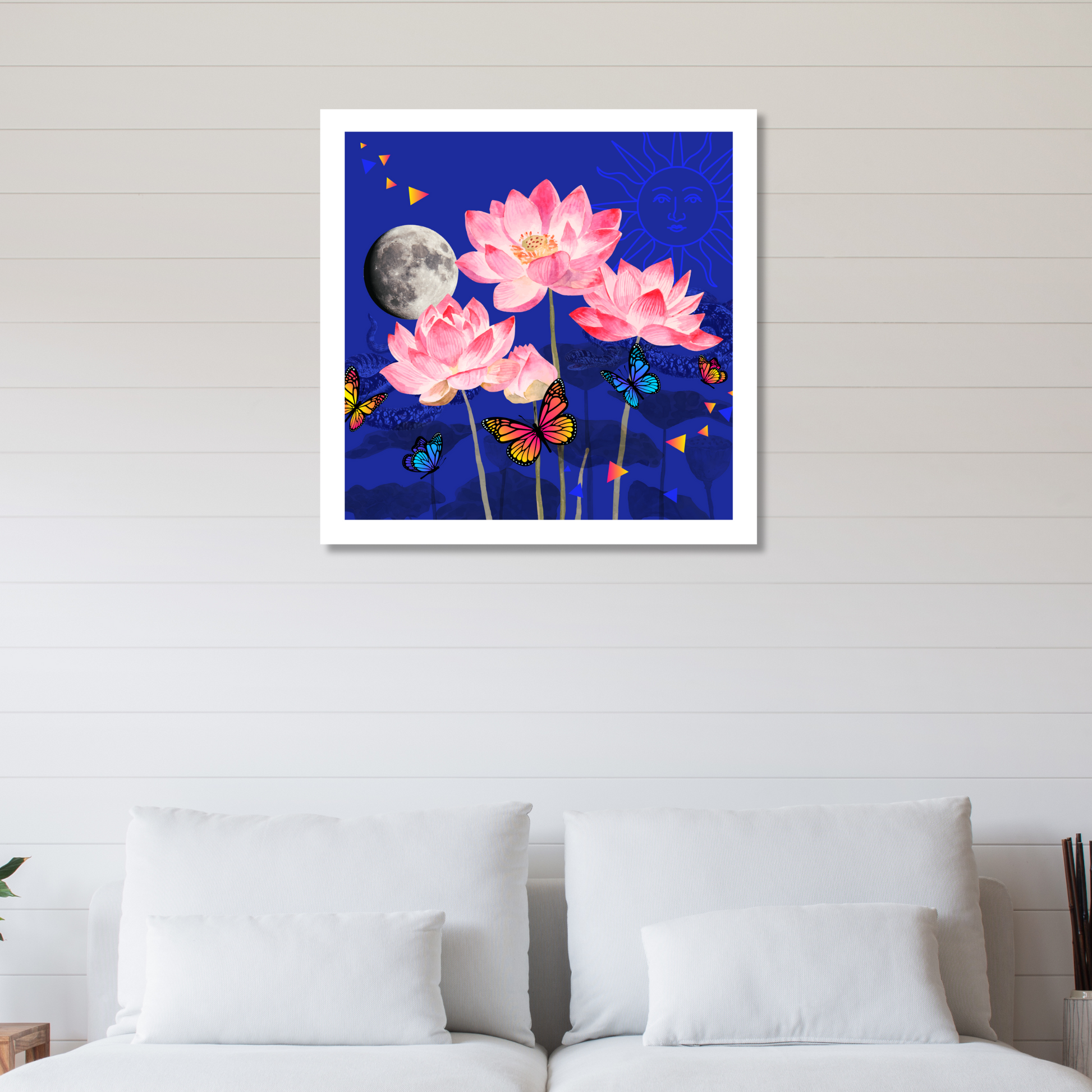 The Rebirth Lotus Flower Art Print displayed on a home wall. This original wall decor highlights a beautiful lotus flower, butterfly, moon, and sun, enhancing the ambiance of any room.