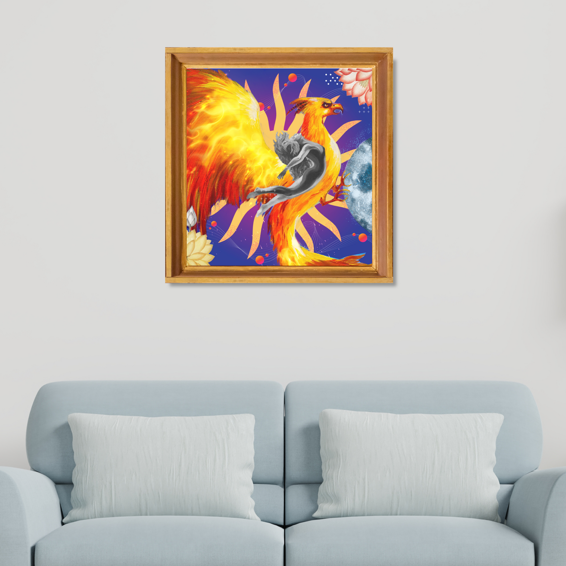 Framed The Rebirth Rising Phoenix Art Print hanging on a home wall. This archetype art print features a woman, golden phoenix, floral elements, and a moon, adding sophistication to your space.
